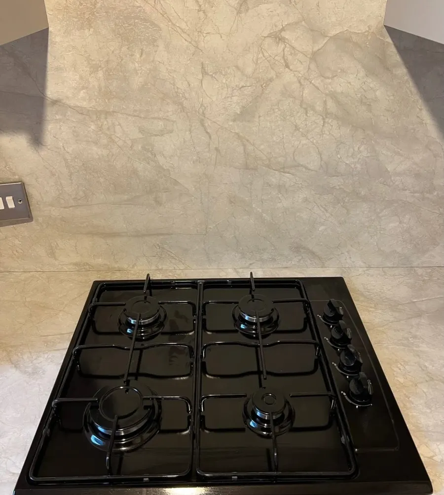Black gas hob set into a marble-effect worktop