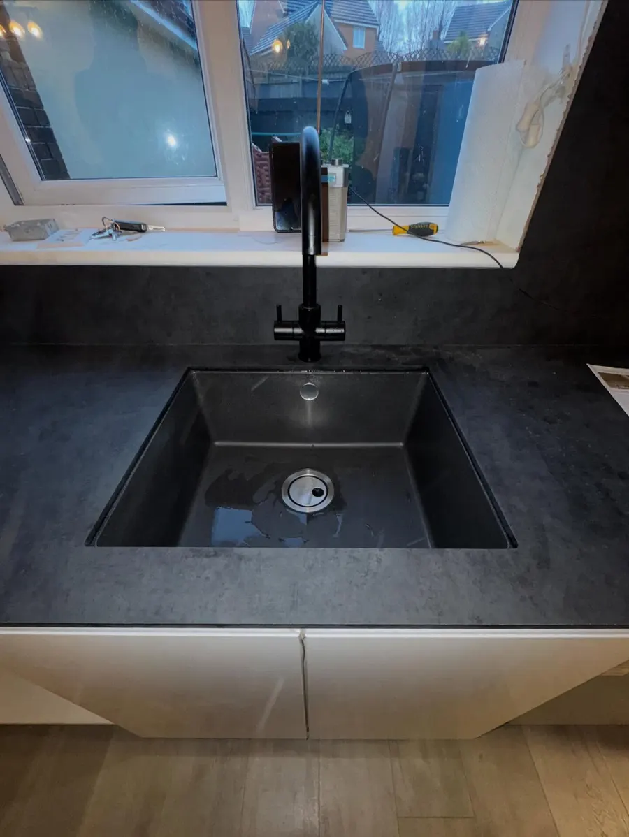 Black undermount sink with matching black mixer tap